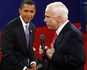 Democrat Barack Obama listens as his Republican opponent, John McCain, answers a question from the audience at their town-hall-style debate last night in Nashville.