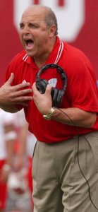 Barry Alvarez , Joe Paterno's friend, led his Wisconsin team to a Big Ten title and Rose Bowl berth from the coaches' box after knee surgery.