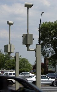 In March, when Philadelphia's red-light cameras were upgraded to digital, some failed to give motorists a grace period of three-tenths of a second.