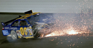 Sparks fly from the car of driver A.J. Allmendinger after a crash during the NASCAR Sprint Cup Series Bank of America 500 at Lowe's Motor Speedway in Concord, N.C.