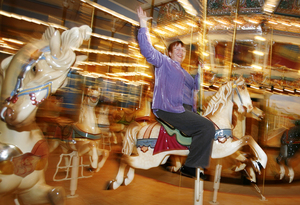 Museum chief Nancy D. Kolb rides the carousel in the museum's new home. She led the drive for the new digs.