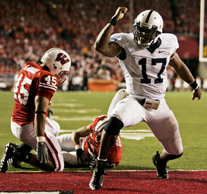 Lions quarterback Daryll Clark celebrates in front of Wisconsin's Dan Moore (45) and Mario Goins after scoring a touchdown.