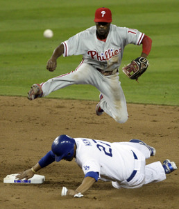 Jimmy Rollins leaps over Matt Kemp to complete a doubleplay.