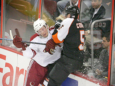 Coyote Dhane Doan smashes into Flyer Braydon Coburn behind the net during the Flyers&acute; overtime win on Saturday night at the Wachovia Center. (Jerry Lodriguss / Staff Photographer)