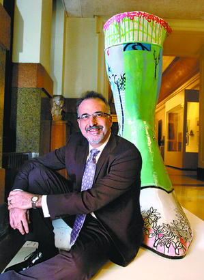 Feet to the fire: At City Hall Gary Steuer sits with a boot sculpture, installed by Moore College of Art.