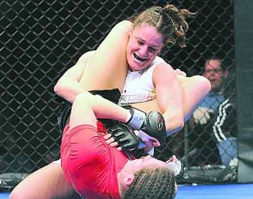 Mixed Martial Arts fighter Tara LaRosa (white suit), of Port Richmond, punches Alexis Davis during the Main Event on Friday at the Tropicana Hotel Casino in Atlantic City, N.J. (Gregg Kohl / For the Daily News) 