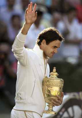 Roger Federer waves to crowd, clutches his Wimbledon trophy after winning his 15th major, as his jacket says (lower left).