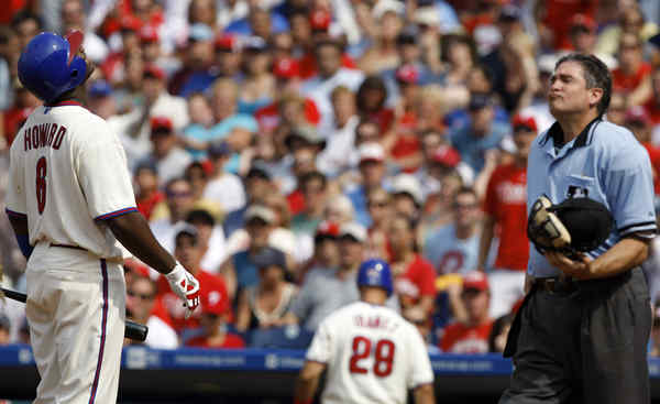 Photo: Philadelphia Shane Victorino uses his teeth to hold his gloves. -  PHI2012072209 