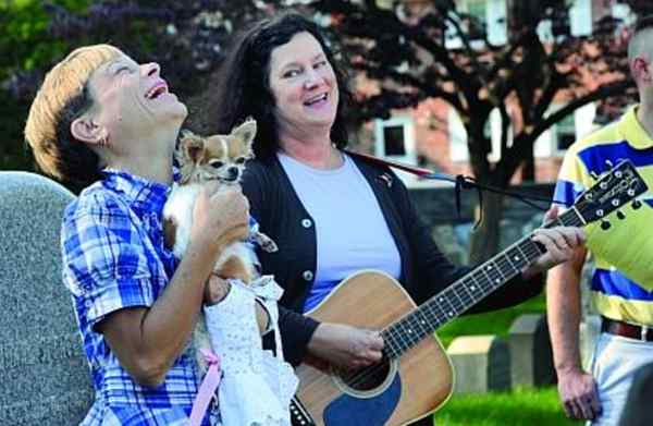 YOU WOULDN&acute;T know to look at it, but the one being blessed in this photo is Cupcake, the dog being held by Angela Bain, of Moorestown, N.J., as guitar-playing Sara Legard looks on during Moorestown&acute;s Trinity Episcopal Church&acute;s 14th annual Blessing of the Animals yesterday.