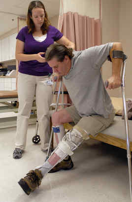 Ryan Mack works with physical therapist Darcy Ziejewski at Virtua Rehabilitation. He was paralyzed in a traffic accident.
