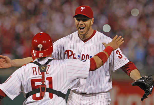 Philadelphia Phillies catcher Carlos Ruiz embraces relief pitcher