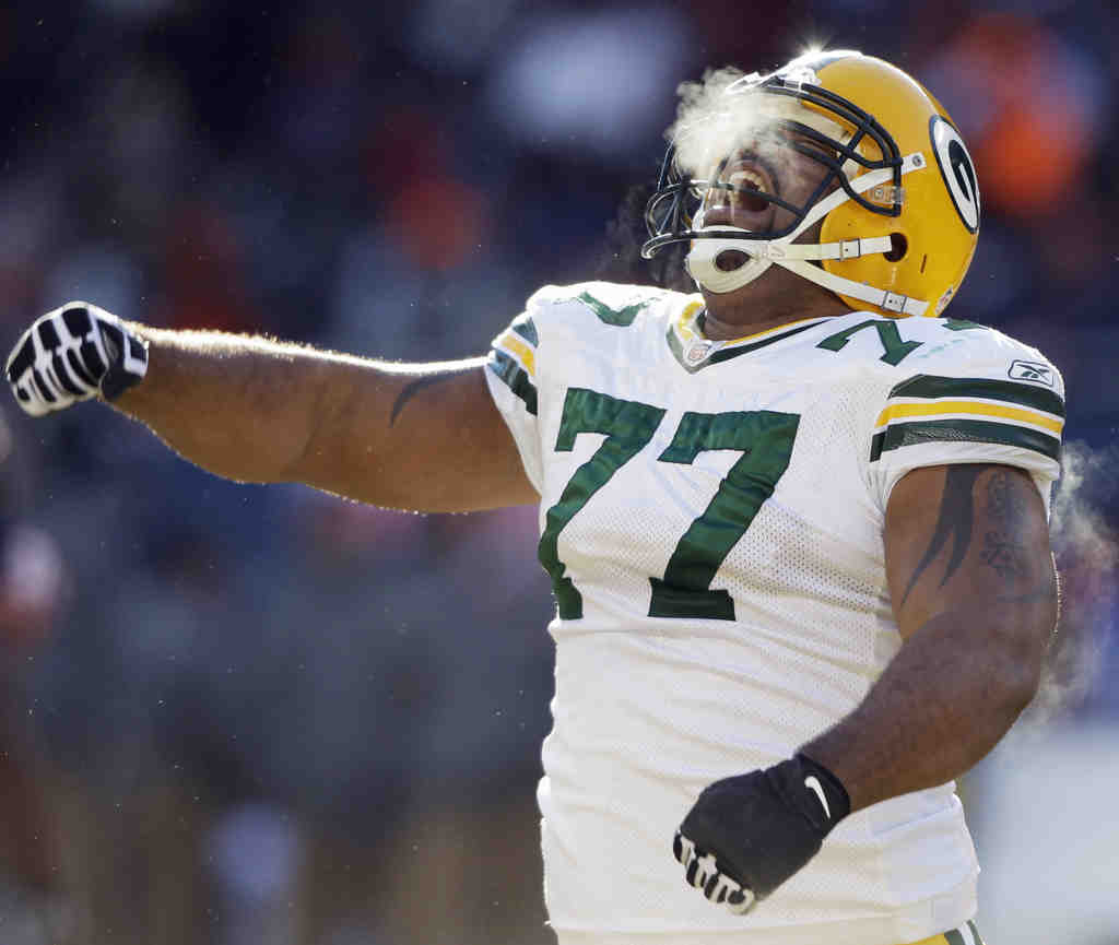 Green Bay Packers B.J. Raji is   hit for his touchdown dance