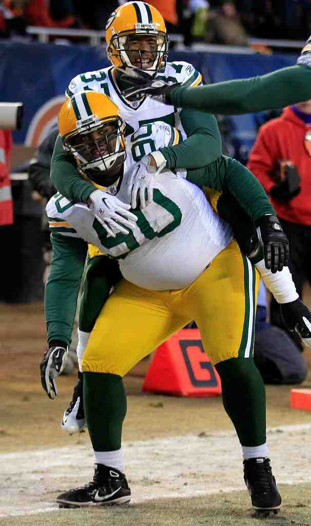 Green Bay Packers B.J. Raji is   hit for his touchdown dance