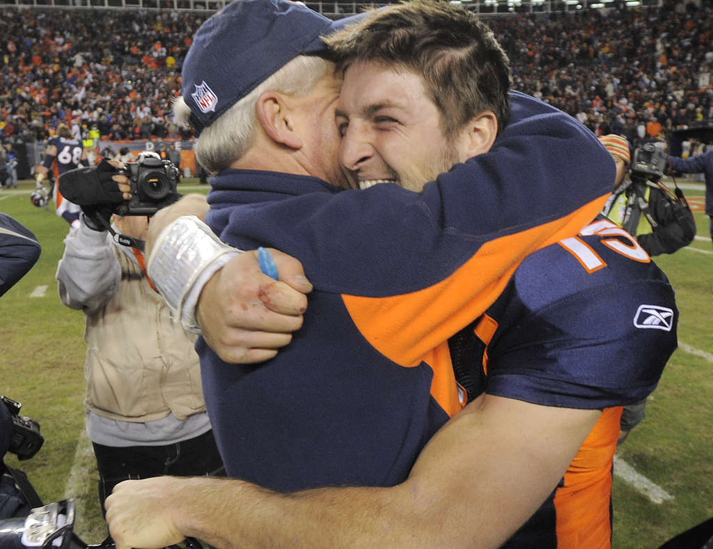 Quarterback Tim Tebow (15) celebrates a score during an NFL game against  the New England Patriots – Denver Broncos History