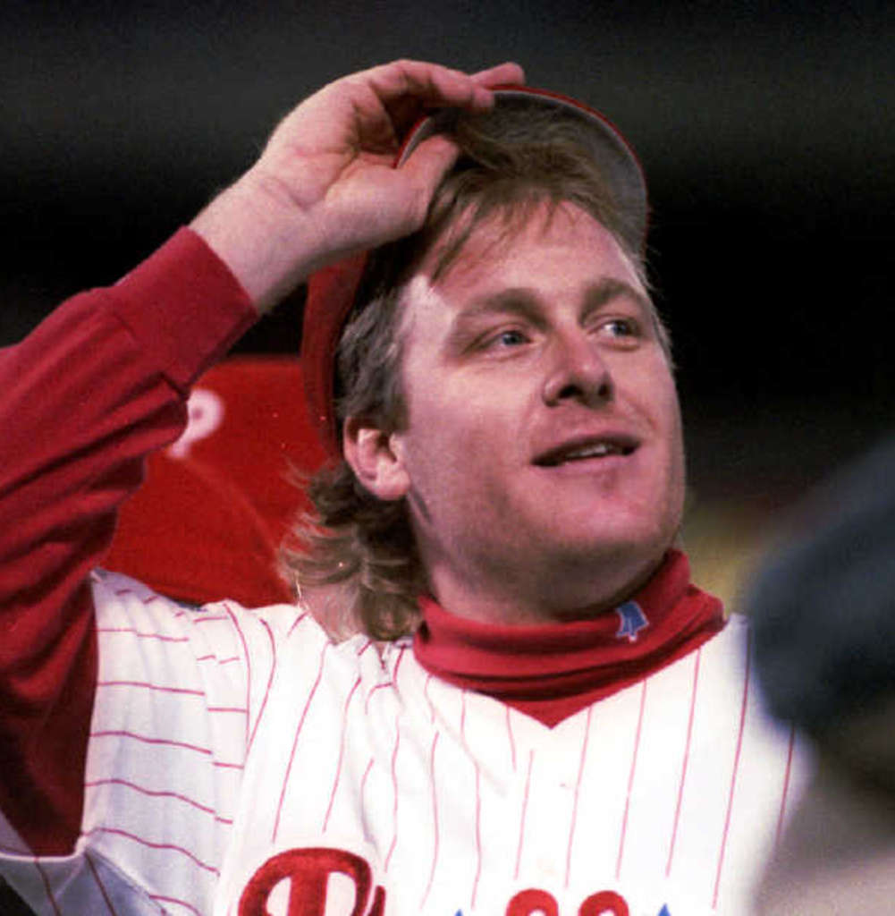 Philadelphia Phillies starting pitcher Curt Schilling covers his head with  a towel in the dugout after Mitch Williams took over from him in the ninth  inning of game 5 of the National