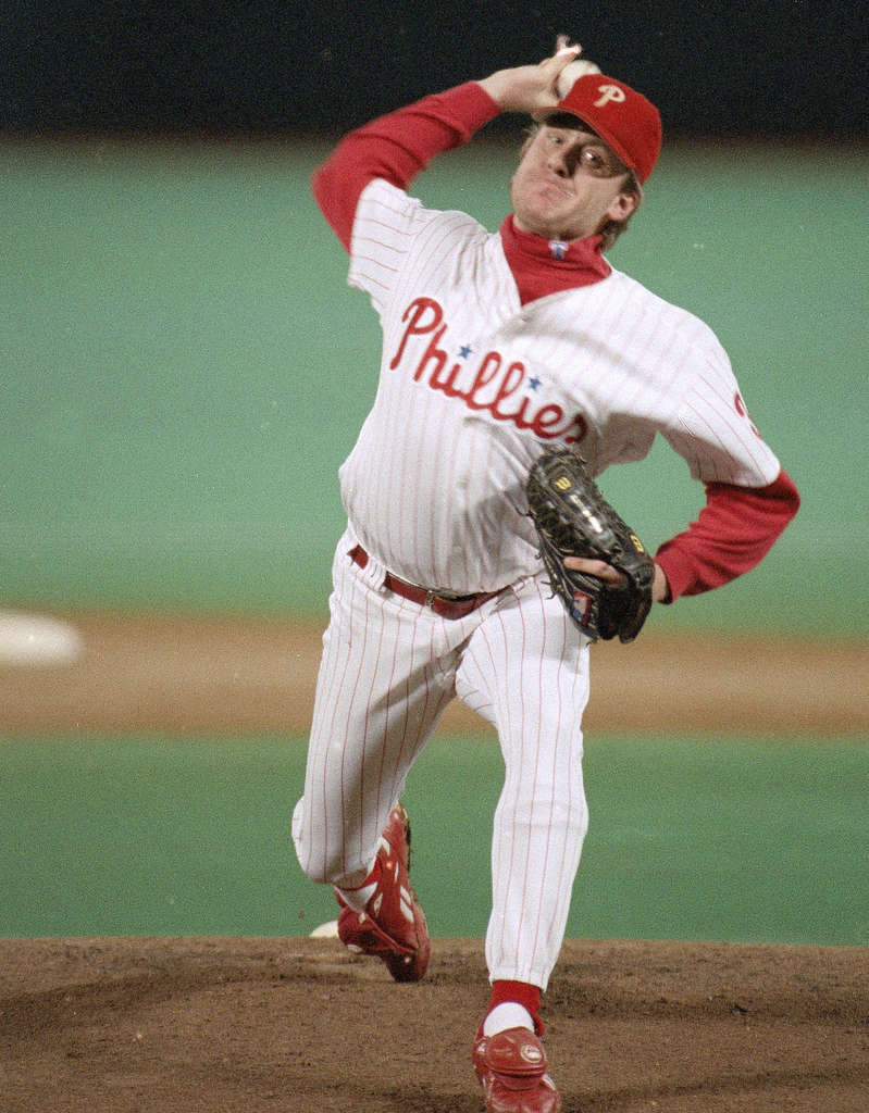 Philadelphia Phillies starting pitcher Curt Schilling covers his head with  a towel in the dugout after Mitch Williams took over from him in the ninth  inning of game 5 of the National