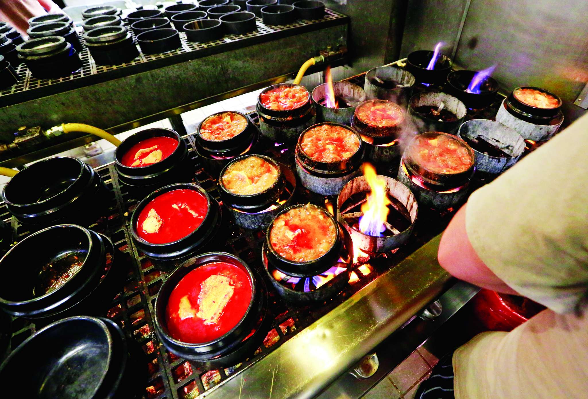 Dubu&acute;s signature dish, soondubu, simmers in pots. The tofu stew takes several weeks to make.