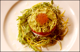 Wasabi-Dressed Ahi Tuna Tartare with creamy Avocado and Salmon Caviar over seasoned sushi rice with scallion oil.