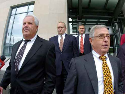 Former Luzerne County Court Judges Michael Conahan, front left, and Mark Ciavarella, front right, leave the U.S. District Courthouse in Scranton, Pa., Sept. 15, 2009, after being arraigned on federal racketeering charges. (AP Photo/The Citizens´ Voice, Mark Moran)