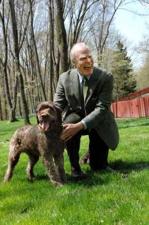 CEO Gordon Gund at his Princeton home with 5-year-old Fozzy Bear. The chairman and CEO of Gund Investment Corp. helped start the Foundation Fighting Blindness which, in turn, helped fund the research that enabled the dog to see.