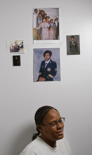 Karen Riggins, 41, a formerly homeless Army veteran, in her efficiency apartment in Eastwick, with photos of herself in the Army and family photos.  