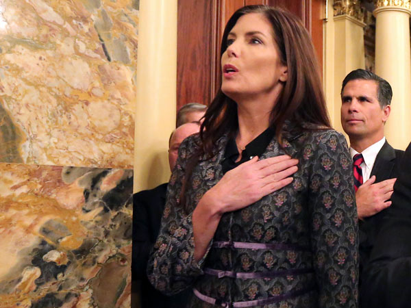 Attorney General Kathleen Kane recites the Pledge of Allegiance while attending the state House of Representatives´ swearing-in in Harrisburg on Tuesday, January 6, 2015. ( DAVID SWANSON / Staff Photographer )