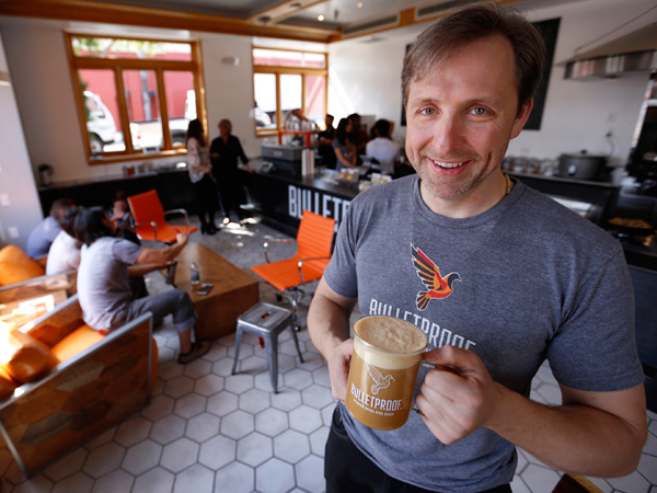Bulletproof Executive founder Dave Asprey holds the signature drink in the hottest new health-meets-coffee craze on April 23, 2015 in his new Santa Monica, Calif., location. Bulletproof Coffee is opening up the cafe that specializes in this butter-fueled coffee that he claims is the perfect way to start the day, and leads to peak human performance. (Al Seib/Los Angeles Times/TNS)