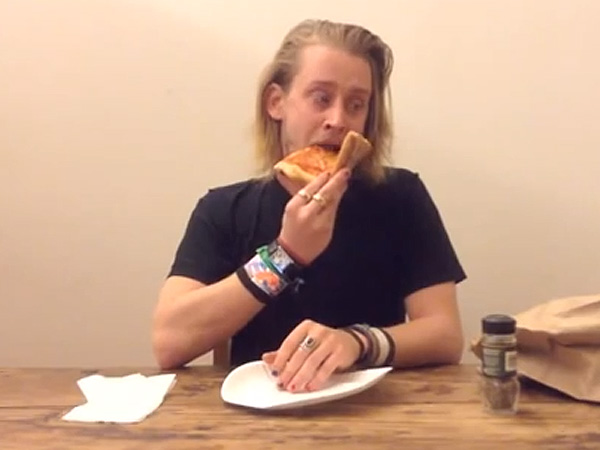 Culkin chowing down on a slice.