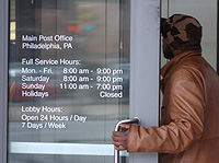 A customer enters Philadelphia&acute;s main post office, 30th and Chestnut Streets. Some post offices will have extended hours. Check the list. 