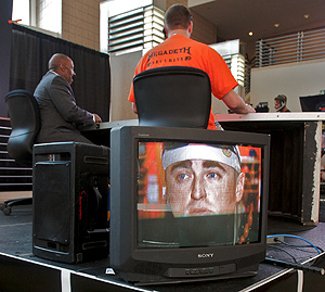 At the Wachovia Center, Broad Street Atrium, Comcast workers get ready for "SportsNite." The cable giant is still striving to dominate the nation’s Internet and telephone service.