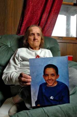Vickie Sue Trivett, 54, holds a photo of her son Jerry at her home near Johnstown, Pa. The teenager was sent to an Oklahoma City treatment center, where he died. Philadelphia´s Department of Human Services sent dozens of children to the same center.