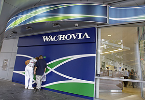Customers outside a Wachovia branch bank in Charlotte, N.C. Wachovia says it lost $8.86 billion in the second quarter, the equivalent of $4.20 per share.