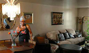 Fifteen year resident Carolyn Bethea in the living room inside her possible $1 home.