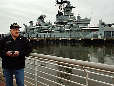 Docent, Dave Wetherspoon, waits for his tour group outside the Battleship New Jersey in Camden. The ship got a makeover and visitors will get new views of the ship. (Sharon Gekoski-Kimmel / Inquirer) 