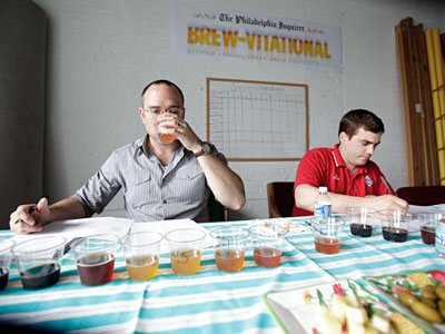 Devin Griffiths (left), home-brewer and beer adventurer, and Rob Cassell, a distiller from Philadelphia Distilling, sample the beer. (David Swanson / Staff<br />Photographer)