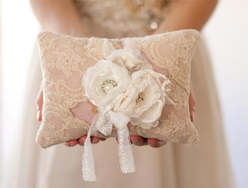 This one of a kind pillow has been handmade with vintage lace, handmade flowers, reclaimed vintage jewelry and rhinestones, and pearl and silver beadwork. A piece of antique lace is used to tie your rings to the pillow. How romantic! Available from Cultivar.