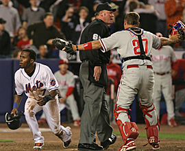 Phillies catcher Chris Coste argues with umpire Ted Barrett after he ruled Mets' Jose Reyes safe on Angel Pagan's game-winning single in the 12th inning last night. (AP)
