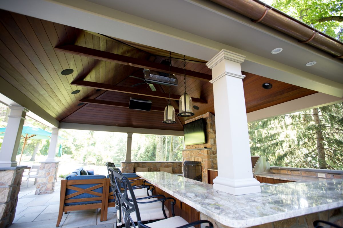 Jen and Tripp Davis’ new outdoor room features a fireplace, pendant lighting, and spots to watch TV, prepare meals, and dine casually. 