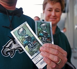 The eco-friendly Eagles print their tickets on recycled paper. A pair was held up last fall by Bruce Thompson of Cherry Hill, as his wife, Kathleen, looked on.