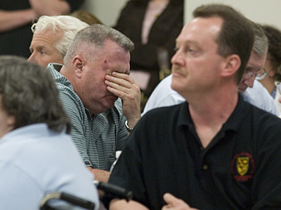 Kevin O&acute;Shea, CEO of the Philadelphia Academy Charter School holds his head at a special meeting of the school board. (Ed Hille / Inquirer)