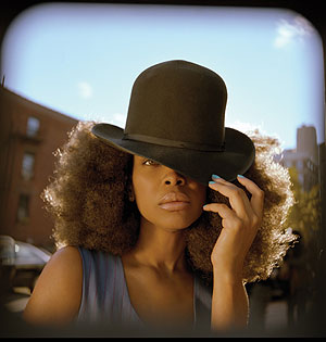Erykah Badu, backed by a 12-member ensemble, brought the crowd to its feet at the Tower last night.