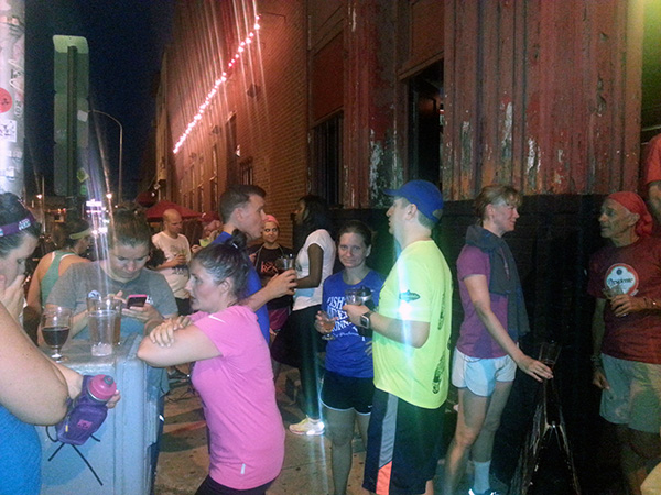 Fishtown Beer Runners stand outside Trestle Inn. 