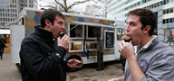 Andy Campbell (left) and Brian Wing (right) eat cupcakes purchased from the Cupcake Truck.