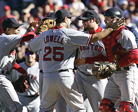 Boston Red Sox&acute;s Mike Lowell celebrates after a win.