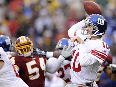 New York Giants quarterback Eli Manning (10) looks to pass against the Washington Redskins as Redskins linebacker H.B. Blades (54) during a Nov. 30 game. (AP)