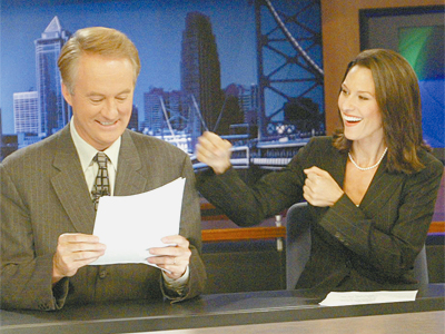 Alycia Lane throws a mock punch at then co-anchor Larry Mendte when they hosted the CBS3 local newscast together. (Daily News file photo)