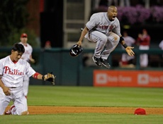 Marlon Anderson leaps in the air in disbelief after being called out on interference after crashing into Tahadhito Iguchi (left) while attempting to break up a game-ending double play.