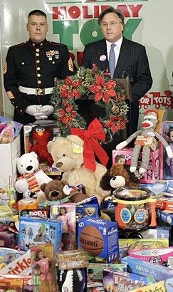 Brian Tierney, right, CEO of Philadelphia Newspapers, announces the Holiday Toy Rush to benefit the Toys For Tots toy drive this morning inside the Daily News and Inquirer building on North Broad Street in Philadelphia. At left is Gunnery Sgt. David Pierson of the U.S. Marine Corps.