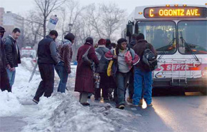 Riders navigate the snow at Broad and Olney. SEPTA planned to run this morning, with service cuts expected later in the day. (Ron Tarver / Staff Photographer)