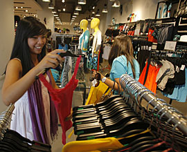 Shopper Ashley Alfonso browses for clothes at the new Hennes & Mauritz (H&M) store at the newly opened The Americana at Brand retail complex in Glendale, Calif. (Damian Dovarganes / AP)